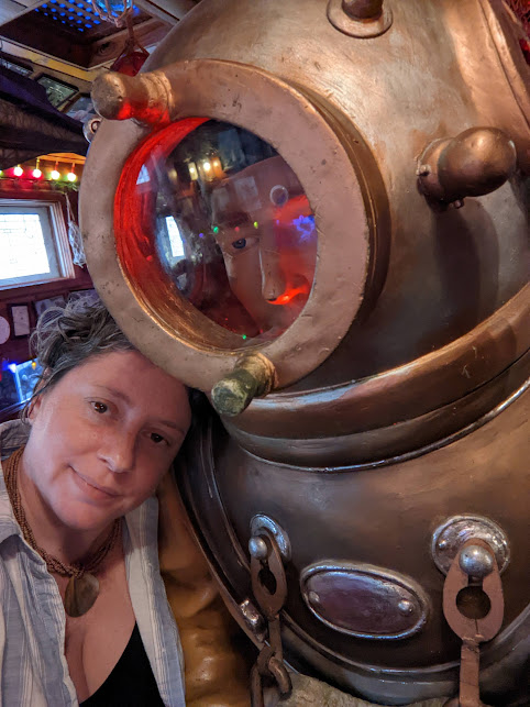 Julia is leaning against a mannequin in antique diving gear. Julia is leaning against a mannequin in antique diving gear.