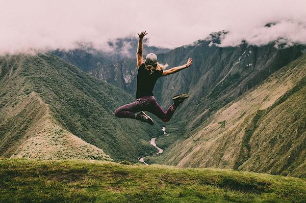 Woman jumping on mountain