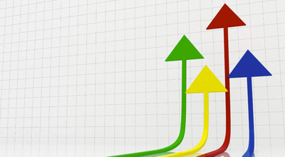 Four colorful arrows—red, green, yellow, and blue—curve upward across a grid background, each pointing in a positive direction. The illustration represents business growth, performance improvement, increasing sales, strategic progress, or achieving organizational goals.