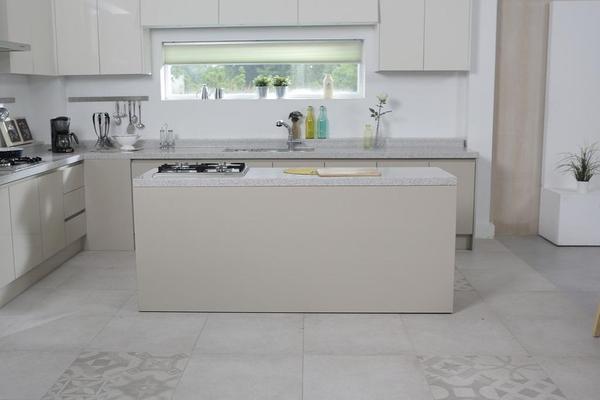 Modern minimalist white kitchen with tile flooring and white kitchen island Modern minimalist white kitchen with tile flooring and white kitchen island
