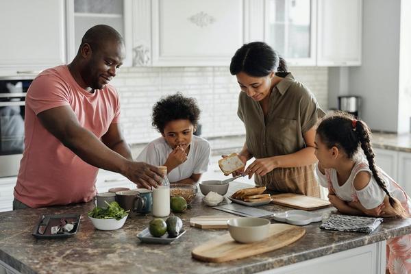 Family cooking dinner together with fresh ingredients