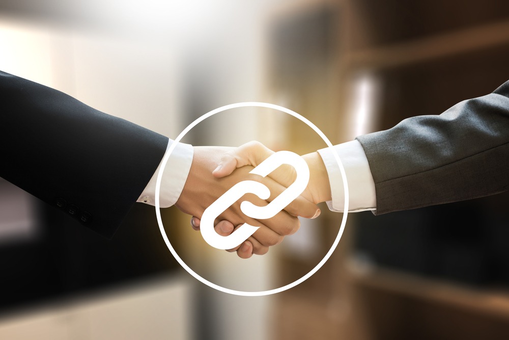 Two people shaking hands with a backlink symbol overlaid. Two people shaking hands with a backlink symbol overlaid.