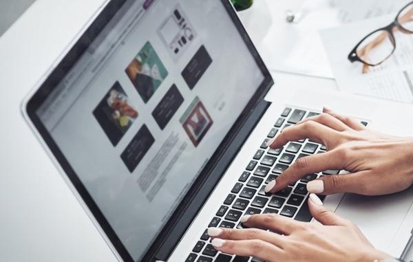 Woman typing on landing page for SEO Woman typing on landing page for SEO