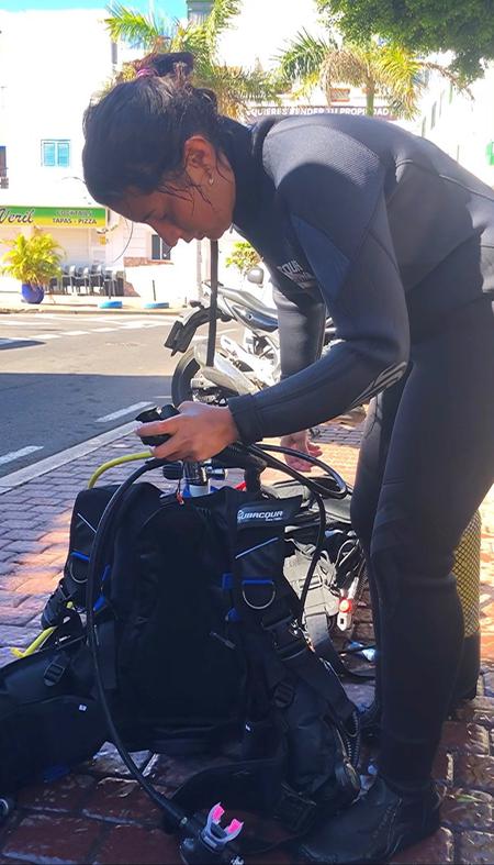 Scuba diving student preparing equipment Scuba diving student preparing equipment