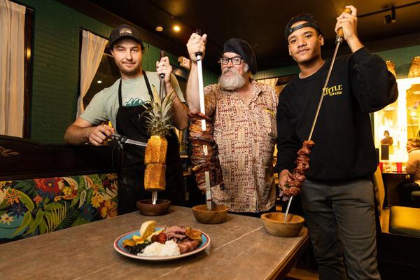 Stephen Lavoie (left) with cinnamon-sugar grilled pineapple, Rick Hunt (middle) with pork ribs and Juan Hernandez (right) with bacon-wrapped filet mignon.