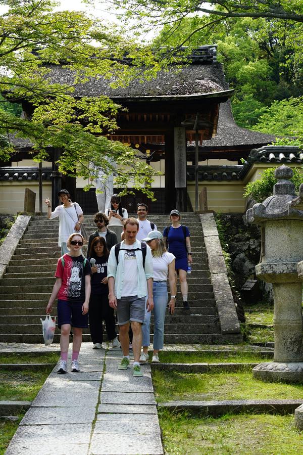 An image showing a group of people in front of a temple in Otsu, Kyoto.