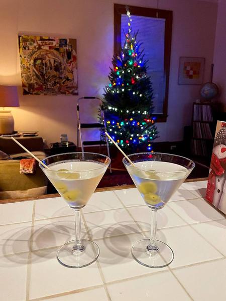 Martini glasses in front of Christmas tree