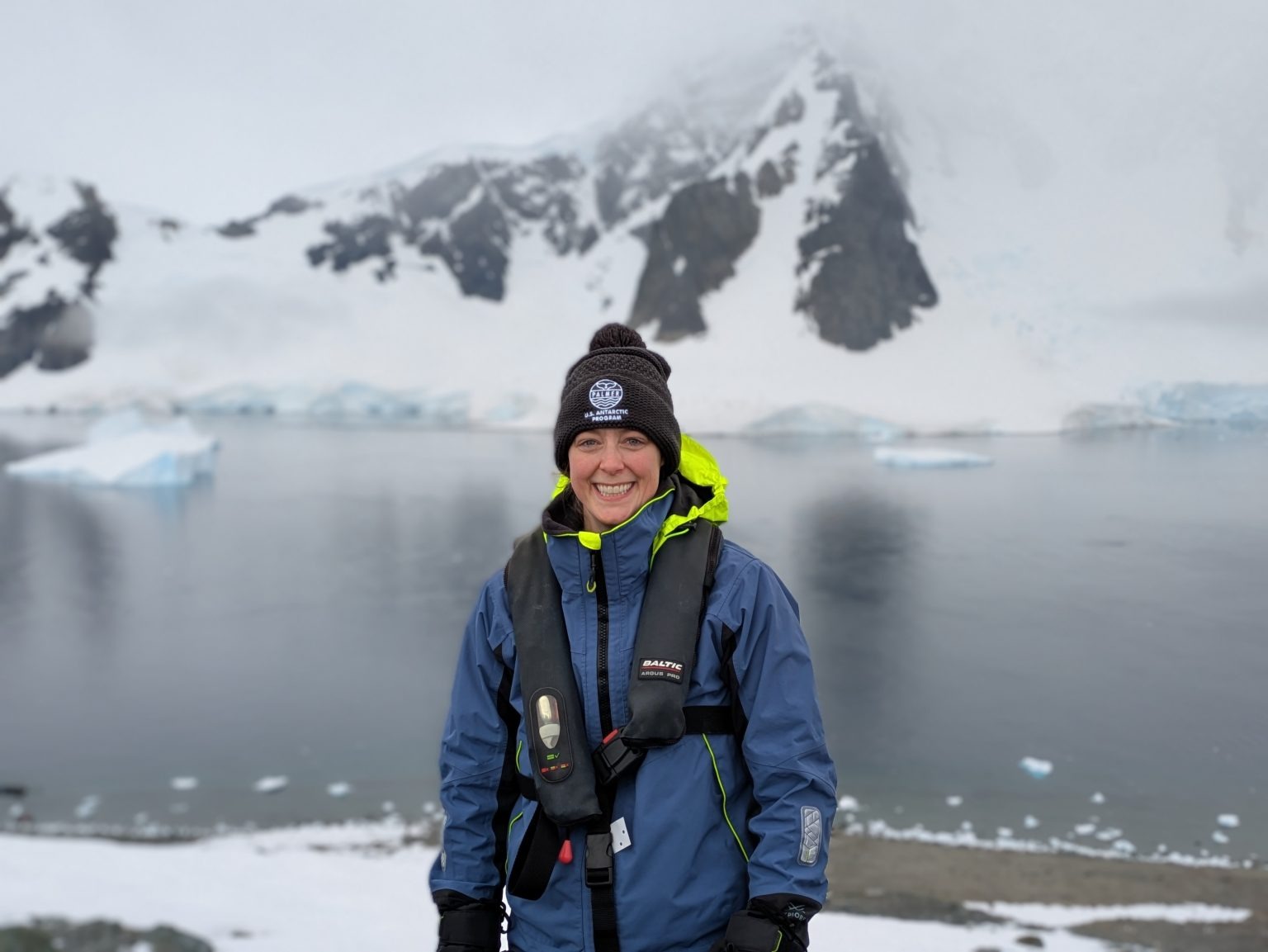 Dr. Kristina Burrack poses on the Antarctica peninsula Dr. Kristina Burrack poses on the Antarctica peninsula