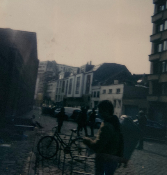 Young male homeless refugees hanging out outside the refugee center