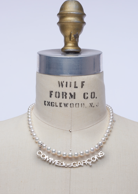 A pearl necklace from the Mikimoto and Comme des Garcons collaboration collection, draped on a mannequin.