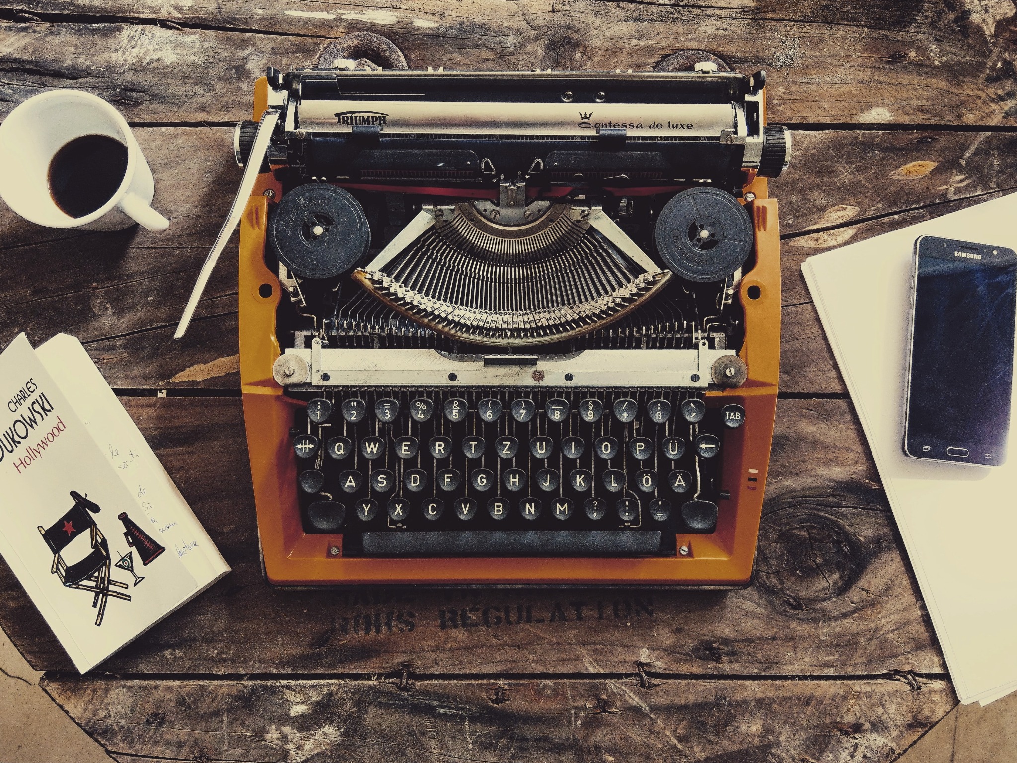 Typewriters and Movie Book with Coffee on a Wooden Table