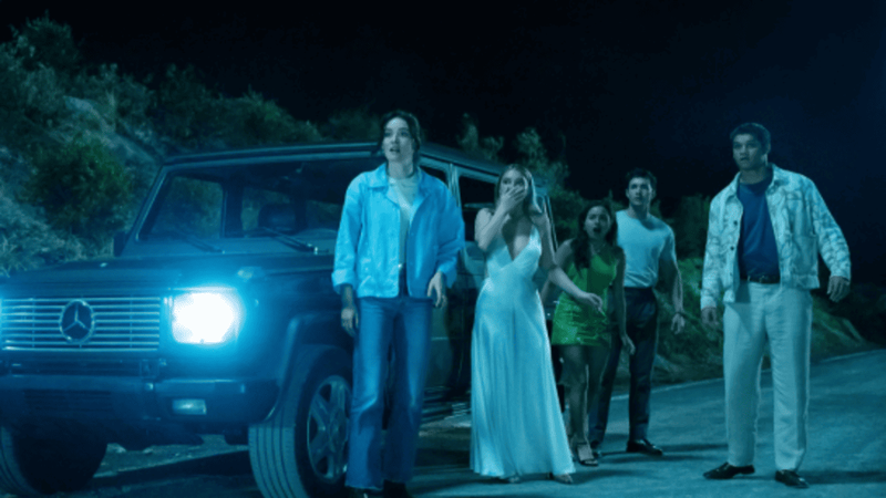 The cast of I Know What You Did Last Summer (2025) look on in horror in a scene from the movie.