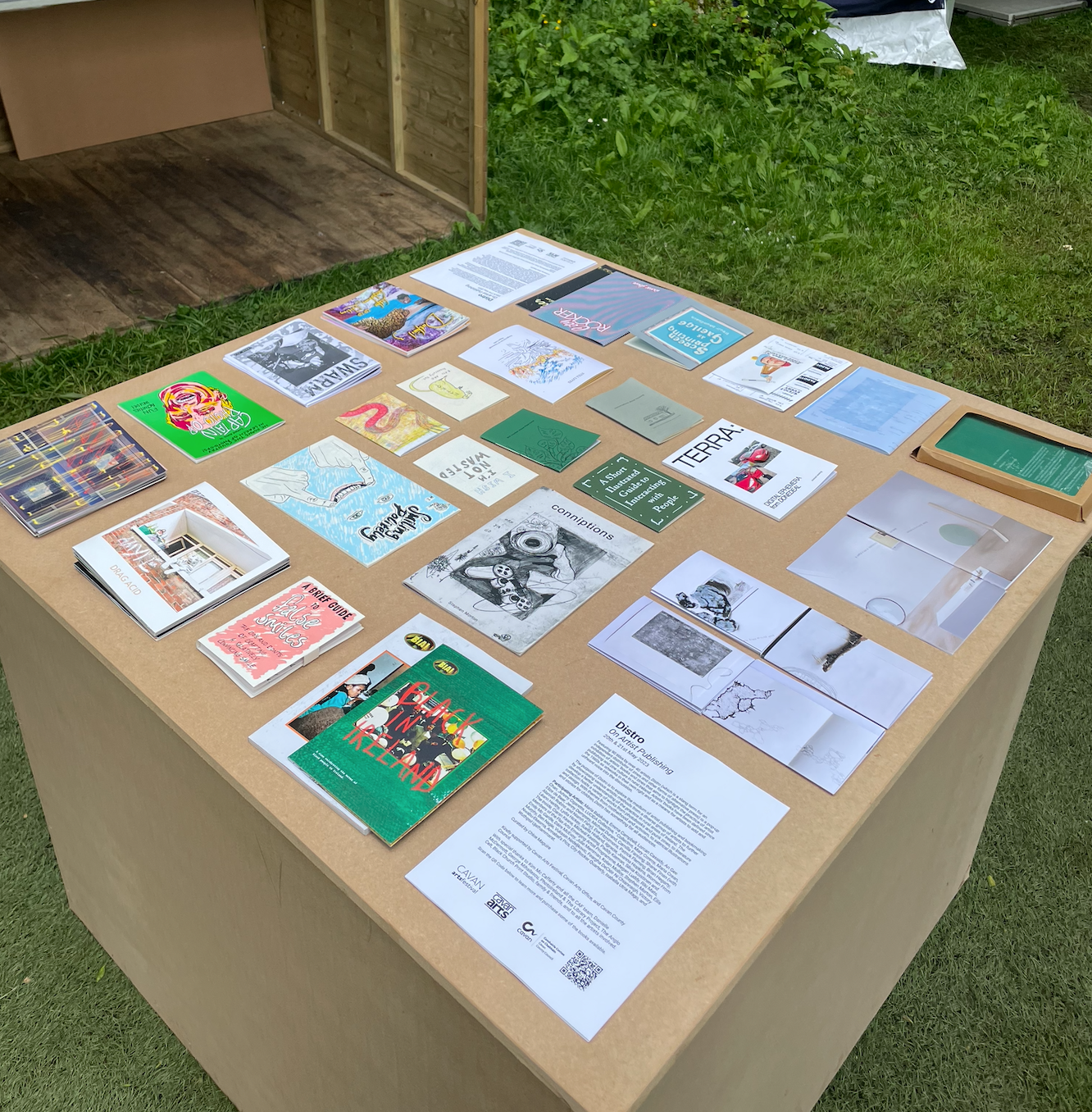 A table with many zines and books, all self-published by artists in Ireland
