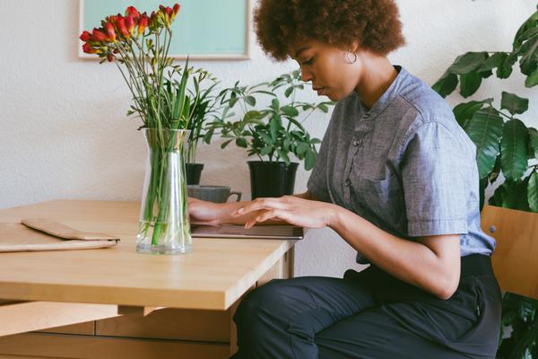 Woman working on wood table with flowers