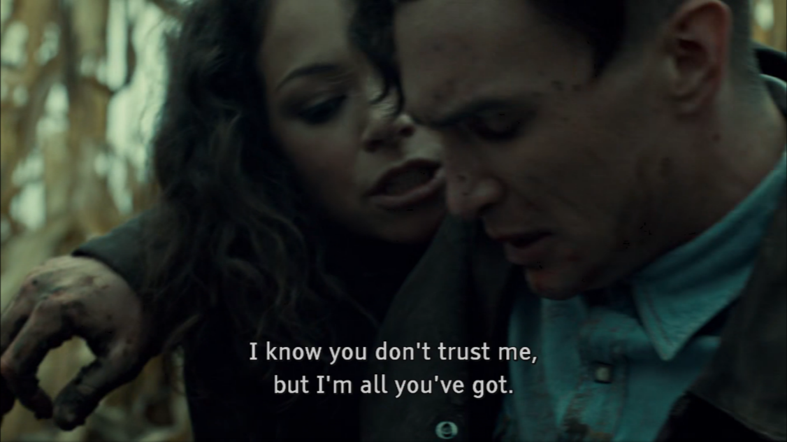 An Orphan Black screenshot is seen. Sarah attempts to help Mark get to his feet, who has just been shot by his mother-in-law, with cornfields seen behind them. Captions state: I know you don't trust me, but I'm all you've got.