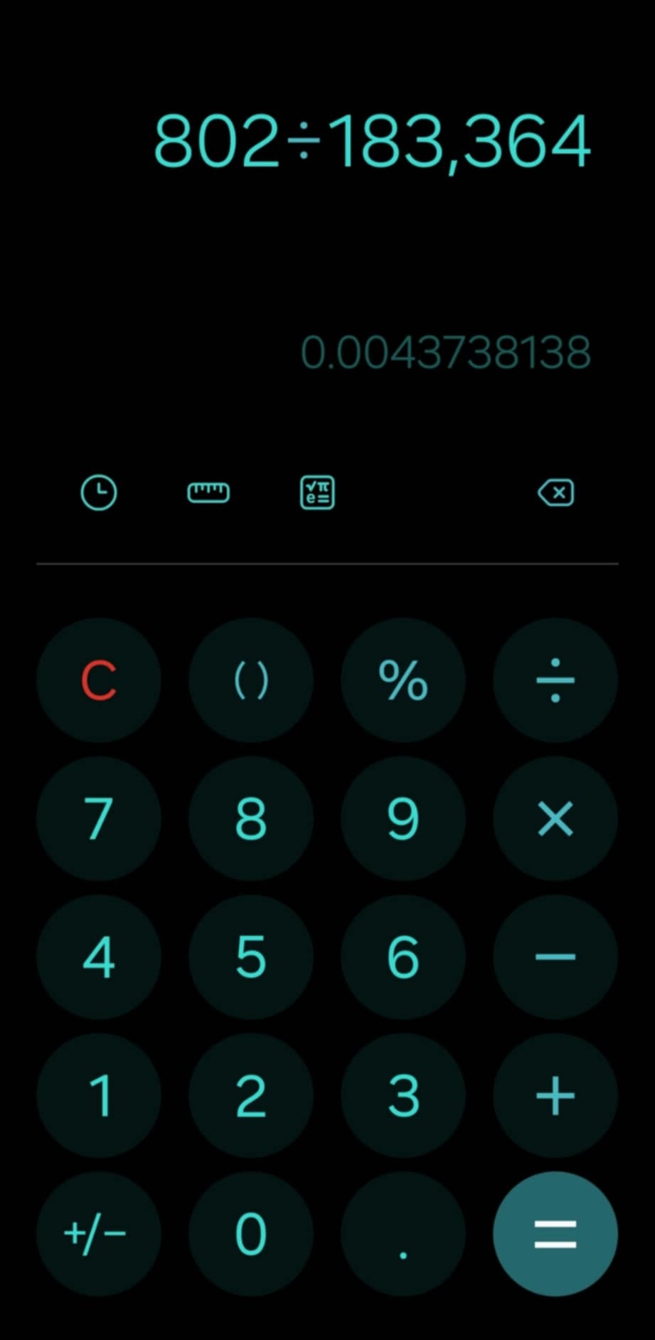 A calculator screenshot is seen. Against a black background, text states: 802/136,364 = 0.0043738138"