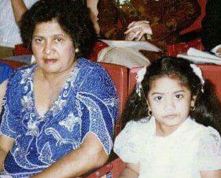 A photo from Krystal's childhood is seen. On the left, is Ruby Goorahoo, her maternal grandmother, while Krystal is on the right. Ruby wears a blue sequined dress, while Krystal wears an uncomfortably frilly white dress.
