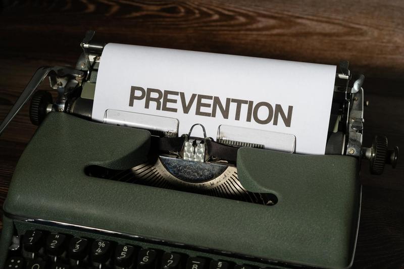 A typewriter is seen, in which, a white sheet of paper has "PREVENTION" stated in black capital letters.