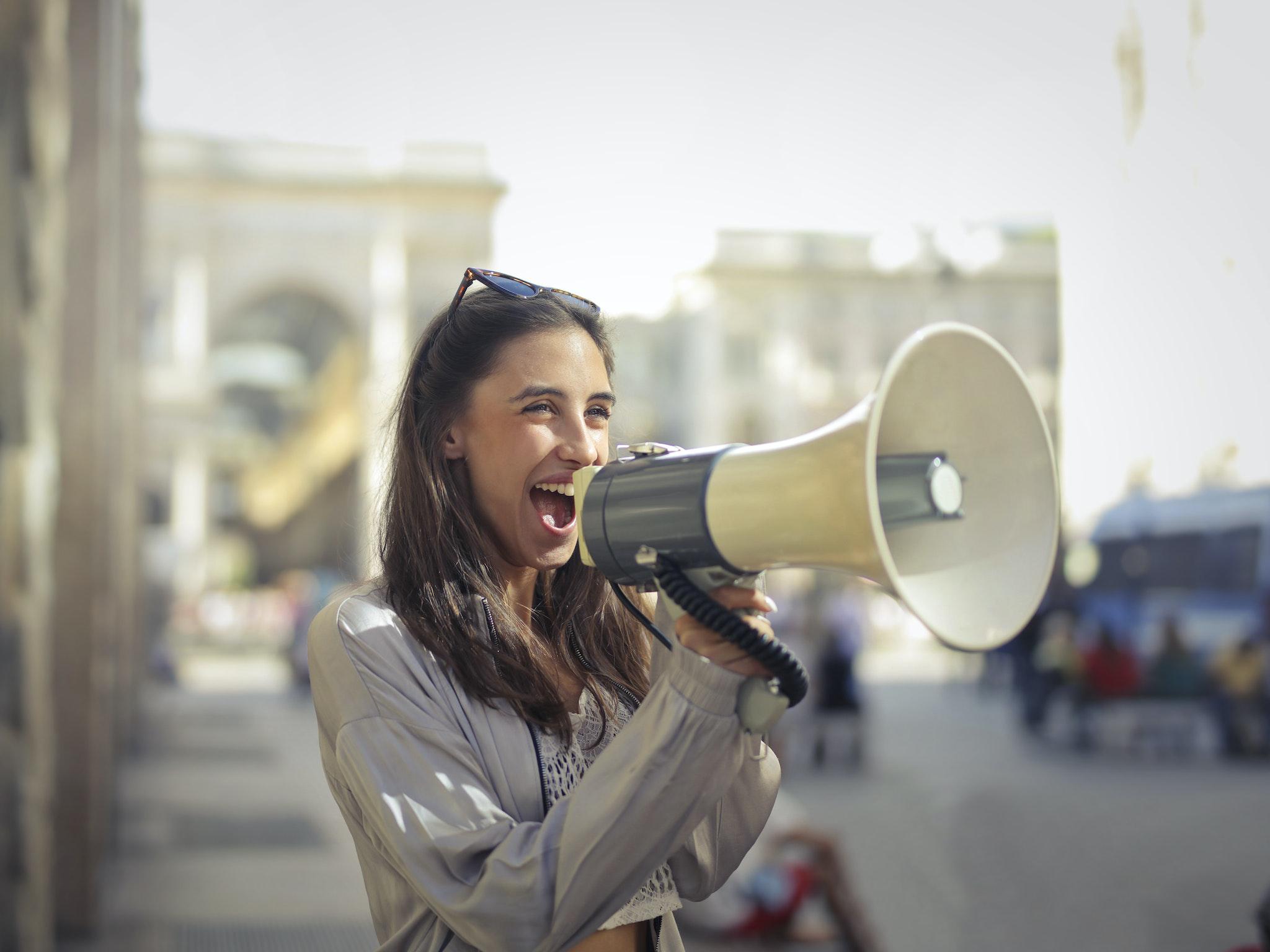 A woman with a megaphone telling people about the effectiveness of whitepapers in SEO A woman with a megaphone telling people about the effectiveness of whitepapers in SEO