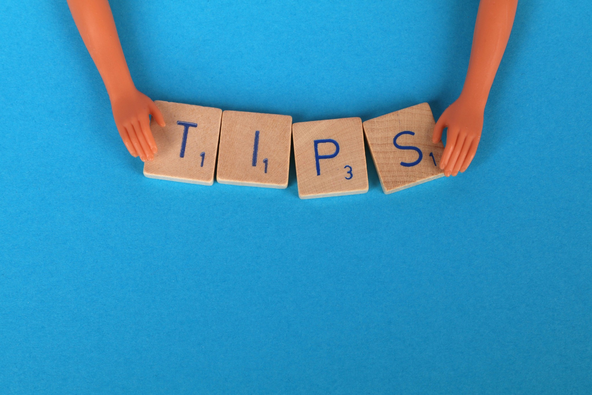 a woman holding blocks with tips written on it