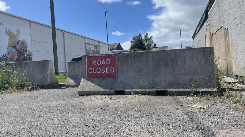 A closed road blocked with a barrier