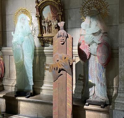 Three glass statutes of mothers with their infants in Marseille's cathedral