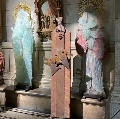 Three glass statues of mothers with their infants in Marseille's cathedral
