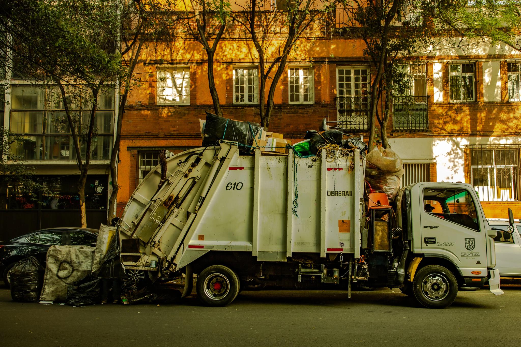 Waste collection truck on an urban street