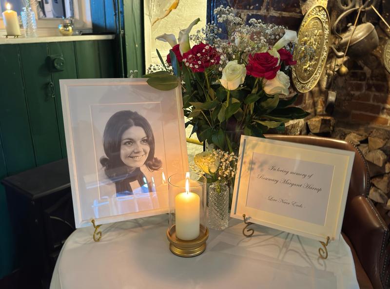 Picture showing a tribute to the writer's mum with a photographer, candle and flowers