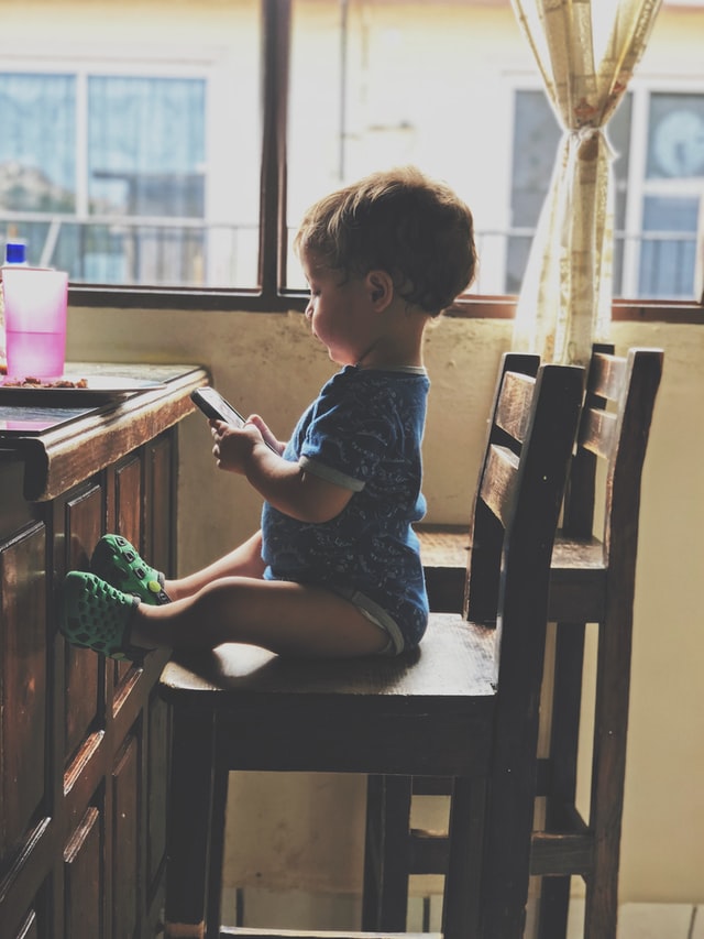 Baby holding cell phone