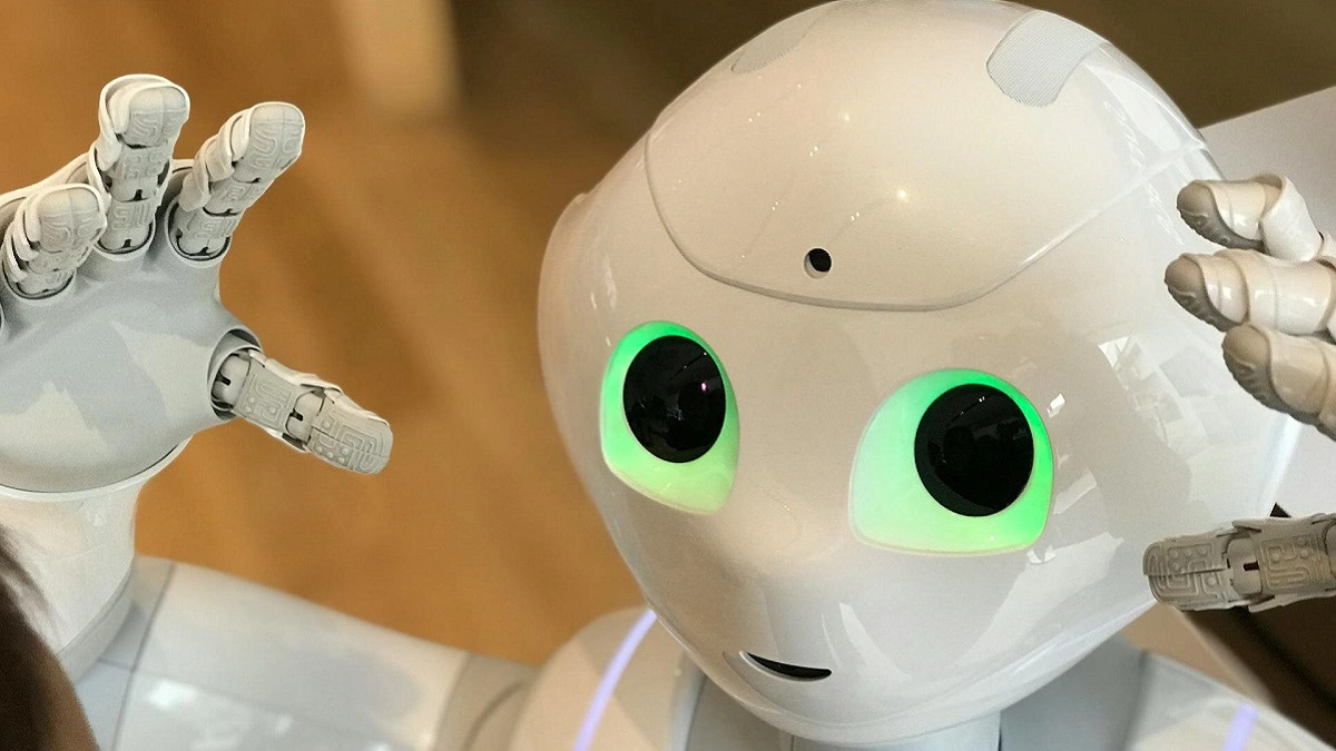 An image of a cute-looking white robot, with it's hands stretched out as though going in for a hug.