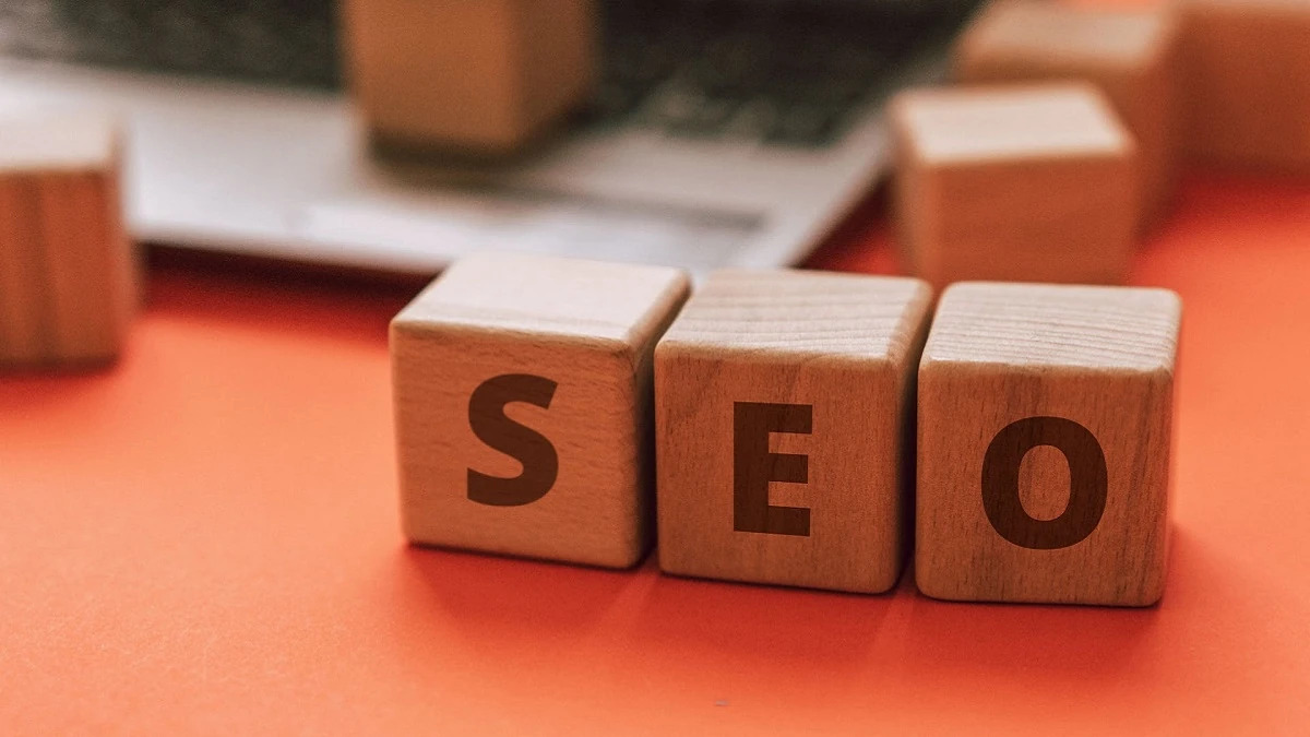 A photo of three cubes, each with a different letter that spells out SEO.