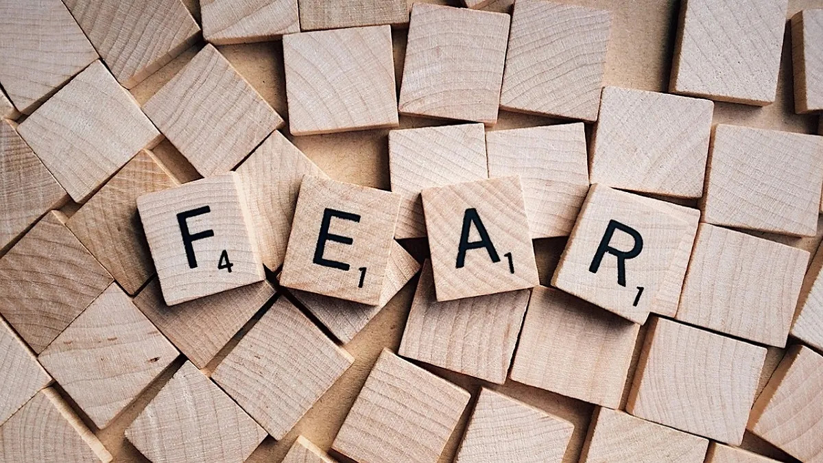 An image of some scrabble-type letters, with the ones on top spelling the word "fear."
