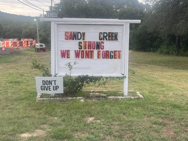 A sign outside Round Mountain Community Center urges Sandy Creek residents to hang tough. A sign outside Round Mountain Community Center urges Sandy Creek residents to hang tough.