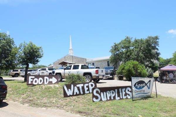 Signs point the way for Hunt residents to get flood relief supplies at the Hunt Baptist Church, 112 Church Drive SW.