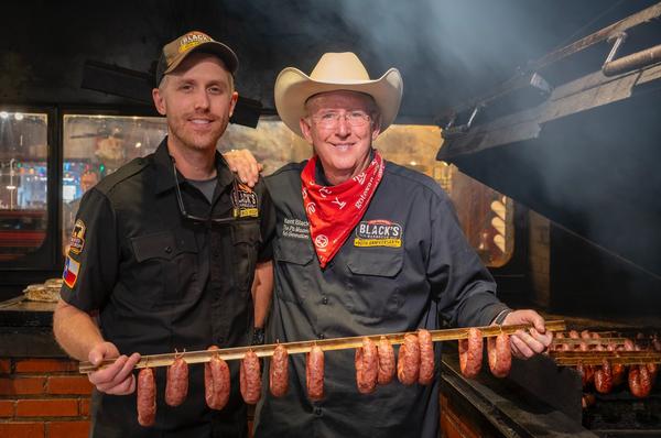Barrett and Kent Black of Black’s Barbecue display some of their sausages.