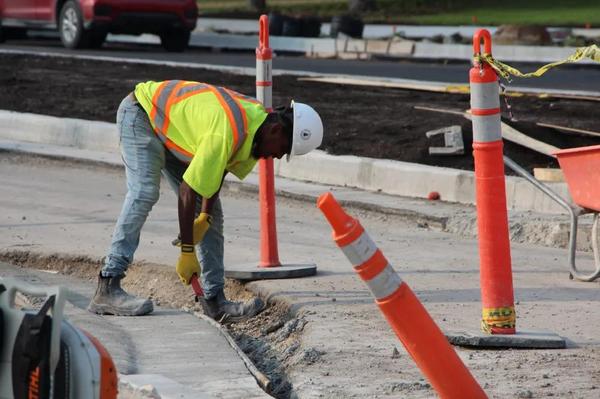 A construction worker repairs a road