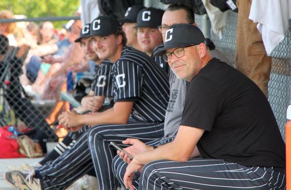 The Carillon Sultans bench smiles at a kid next to the camera