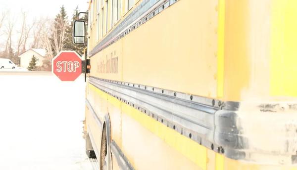 A school bus extends its stop sign