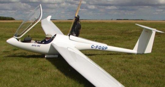 A glider lays on the grass in Starbuck, Man.