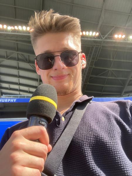 A selfie from Ben Little wearing a navy polo shirt at Princess Auto Stadium during a Manitoba Bisons football game.