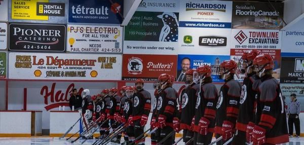 Picture of the La Broquerie Habs junior hockey team celebrating their first home opener at HyLife Centre in La Broquerie, Manitoba.