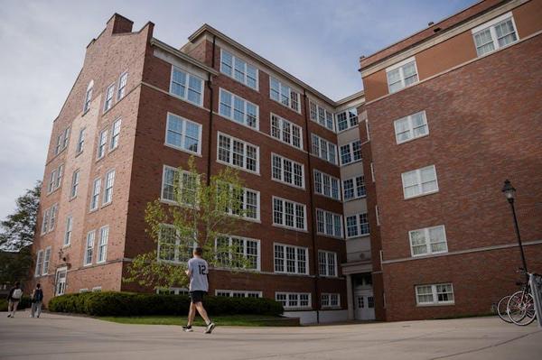 Students walk by Porter Hall, April 22, 2025, in Athens. Porter Hall houses the plant biology classes.