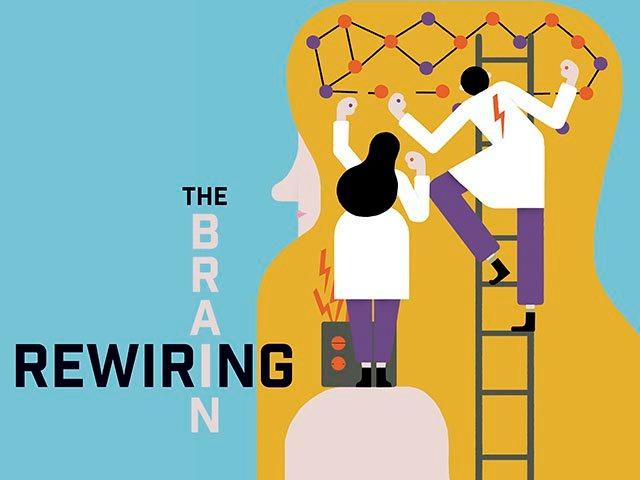 Two small scientists  connect electrodes onto a blonde woman's head. One scientist stands next to a battery. Another is on a ladder.