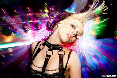 Doug Hac photograph of a blond woman dancing in a club with colorful lights flashing all around her