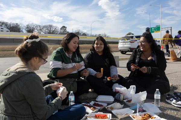Attendees gather along the curb at Golden Triangle Mall to share snacks together on Jan. 25, 2025. Photo by Rebecca Hsu.