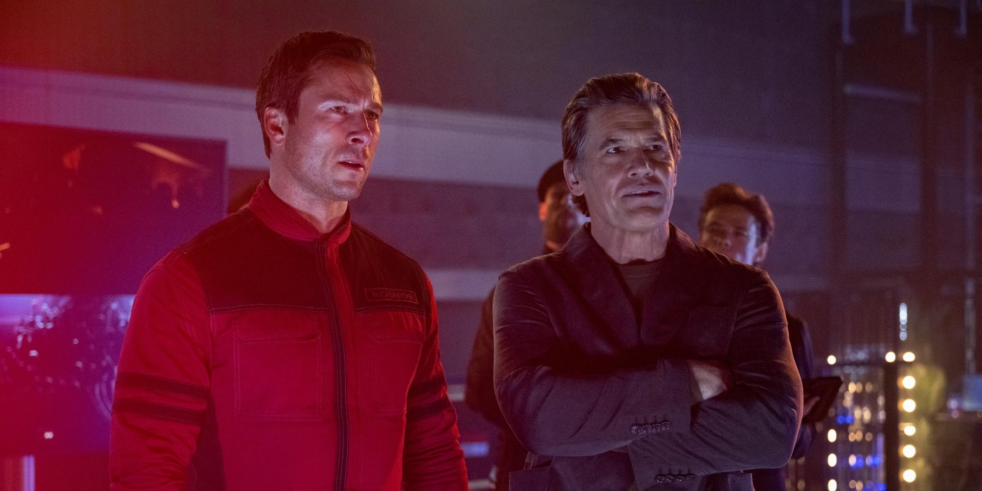 Glen Powell and Josh Brolin standing together in The Running Man