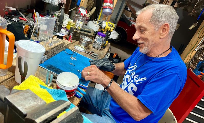 Ron Watson, AKA the Cross Man, polished aluminum crosses in his workshop.