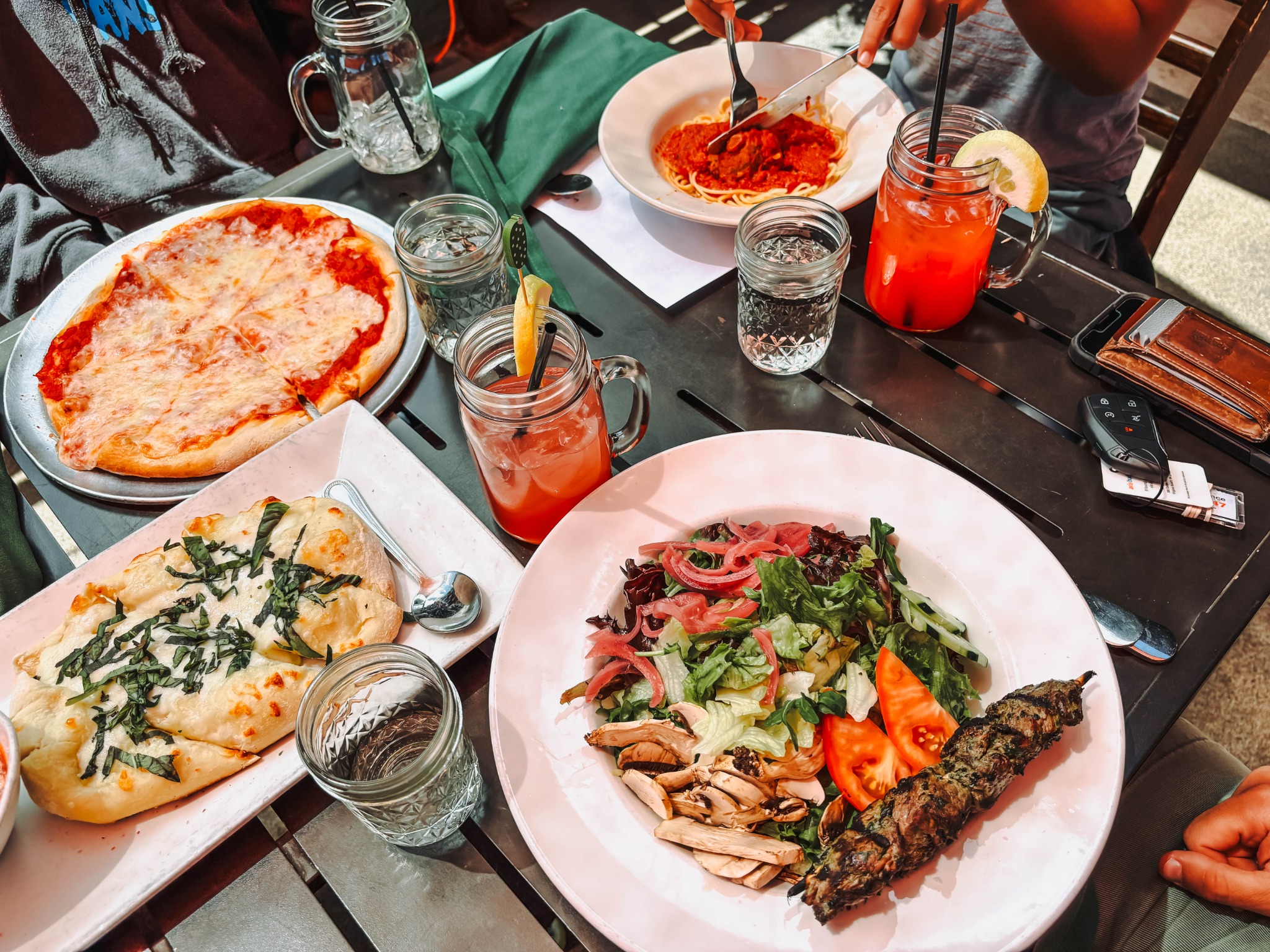 Family meal with pizza, salad, and drinks at Hideaway House in Sedona, Arizona