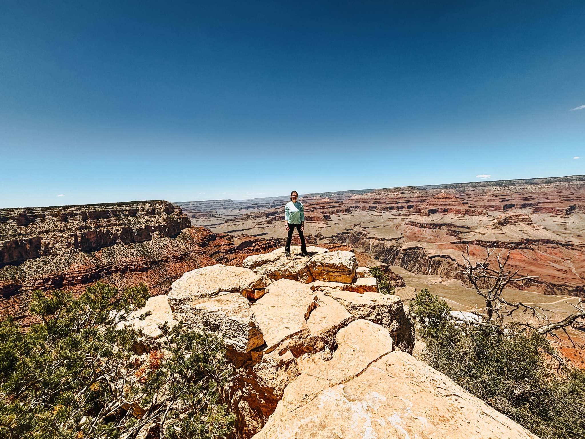 Hiker standing at an overlook along the Grand Canyon South Rim in Arizona